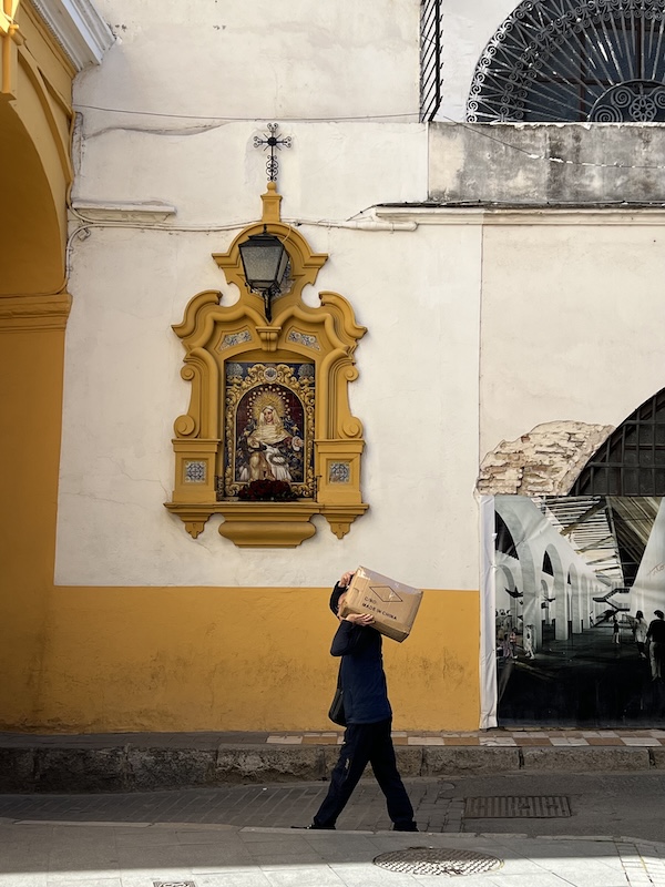The same man, a few steps later, appears to be making an offering to the Divine.